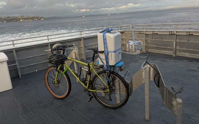 Dehumidifier strapped to a bike that is on a boat