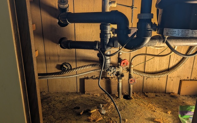 Crammed plumbing under the kitchen sink